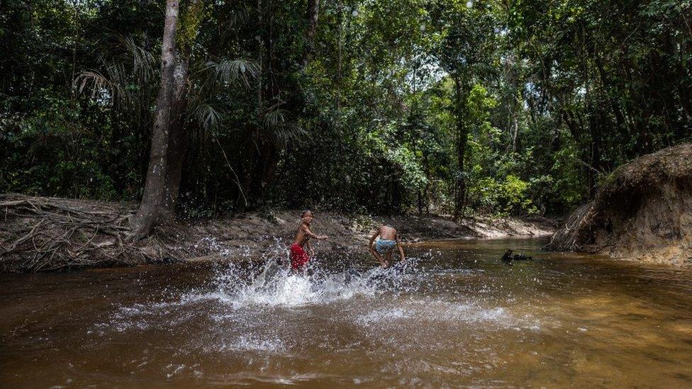 Children play in the river