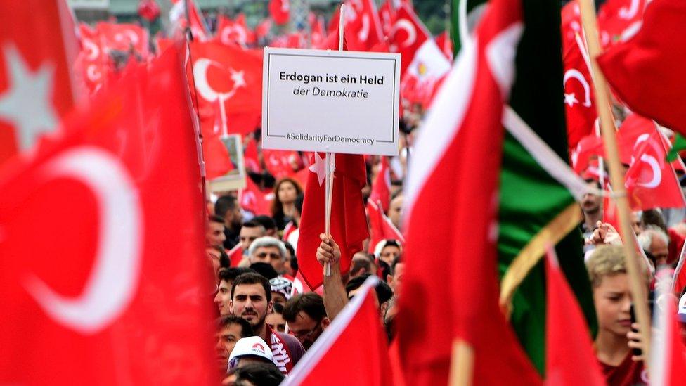 Supporters of Turkish President Recep Tayyip Erdogan rally at a gathering on 31 July 2016 in Cologne, Germany.