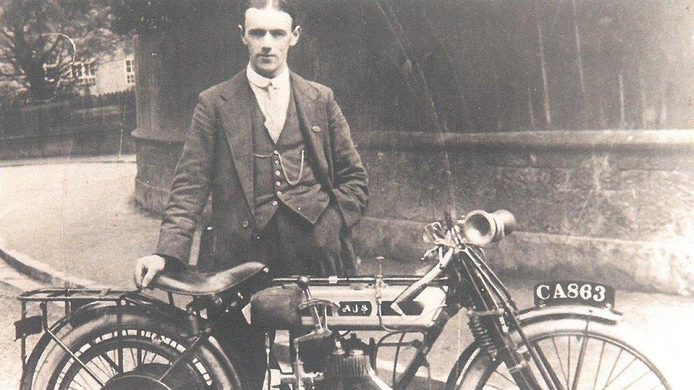 Billy Jones standing behind the motorcycle