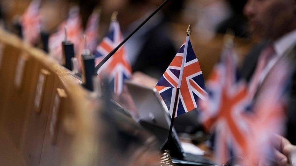 Union Jack flags on desks in the European Parliament