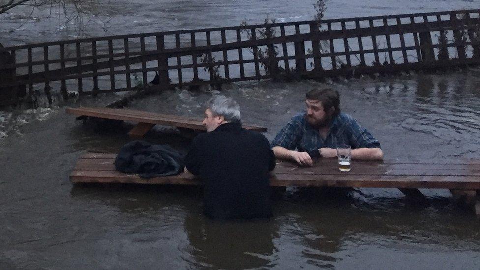 John Kelly and Steve Holt having a pint in a flooded beer garden