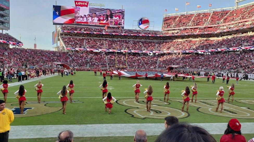 A kneeling cheerleader