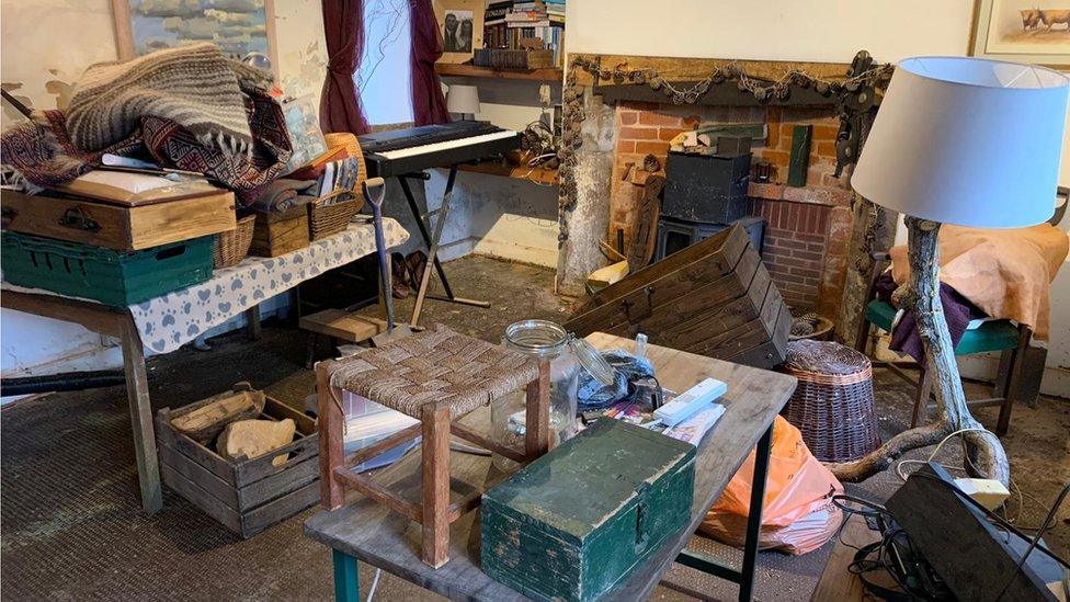 Household items raised high on tables with a bare floor below