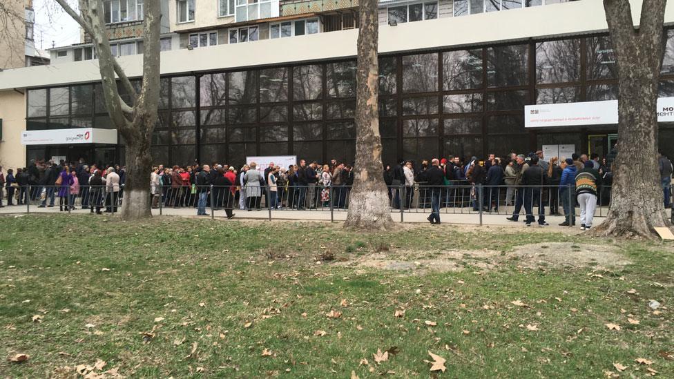 People queue for a long time to change Ukrainian documents to Russian ones