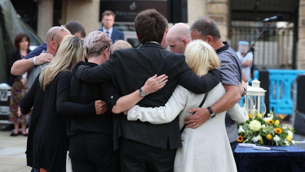 Families of the victims came together to light candles at a vigil in Reading on Saturday