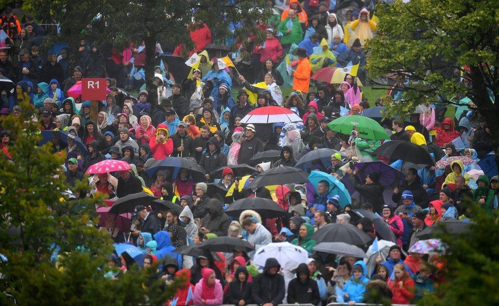 Thousands of people wait under umbrellas for the Pope's arrival at Knock shrine