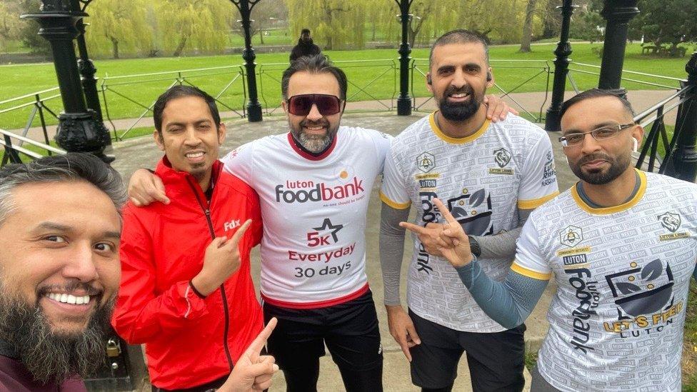 Bilal Hussain with members of the community on a bandstand