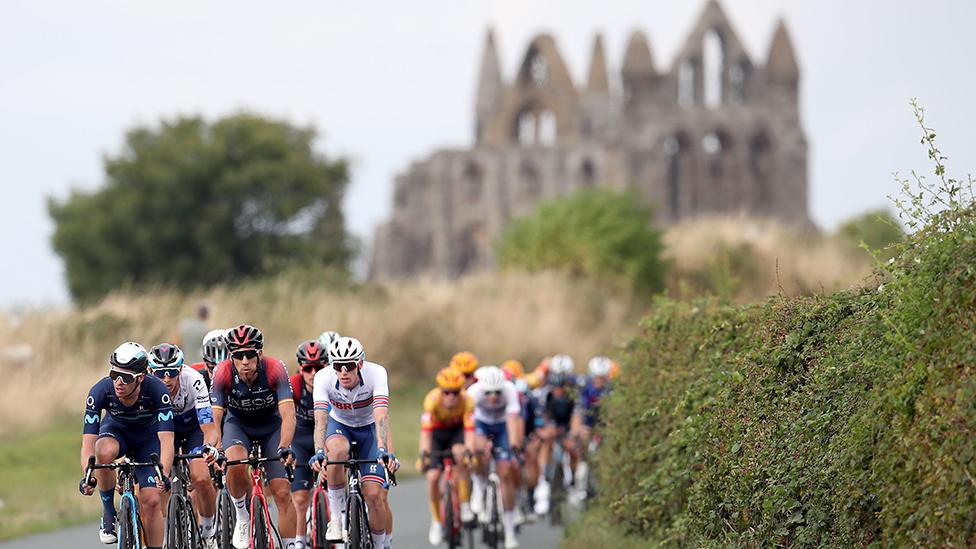 Cyclists pass Whitby Abbey