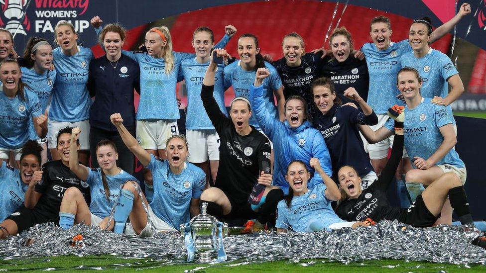 Manchester City players celebrate winning the Women's FA Cup trophy