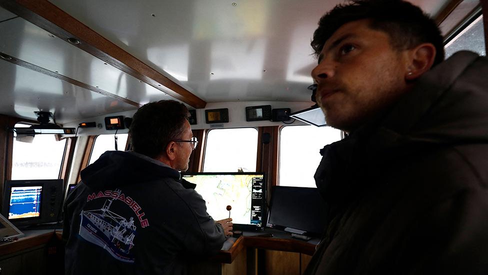 French fishermen protest on their boat in front of the port of Saint Helier off the British island of Jersey to draw attention to what they see as unfair restrictions on their ability to fish in UK waters after Brexit, on May 6, 2021