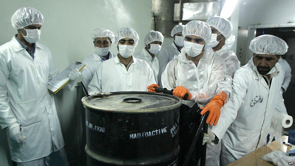 Iranian technicians remove a container of radioactive uranium, 'yellow cake', sealed by the International Atomic Energy Agency, to be used at the Isfahan Uranium Conversion Facilities (UCF), 420 kms south of Tehran, 08 August 2005.