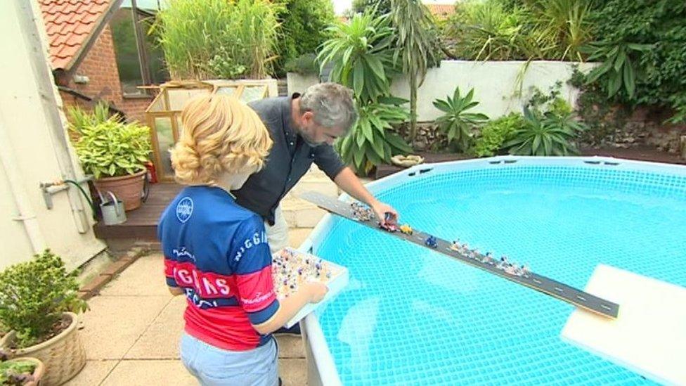 Mr Martin and his son Henri stage a scene over their paddling pool