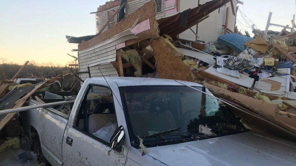 Pick up truck buried by the rubble of the family's destroyed house