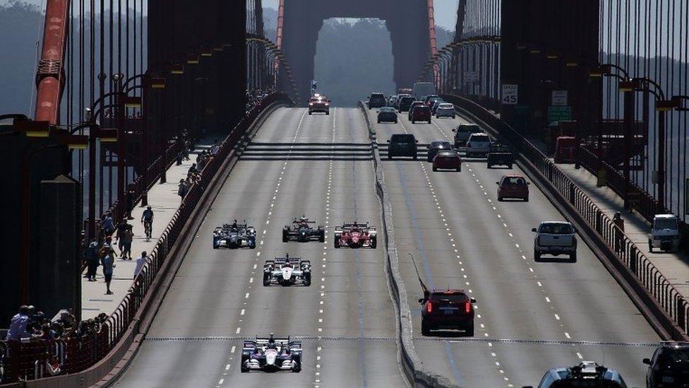 Indy cars drive across the Golden Gate Bridge on August 27, 2015 in Sausalito, California