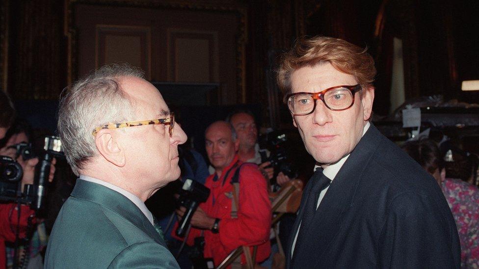 French designer Yves Saint Laurent (R) talks to his fashion house chairman Pierre Bergé on 29 July 1992 in Paris, during the autumn-winter 1992-93 haute couture collections.