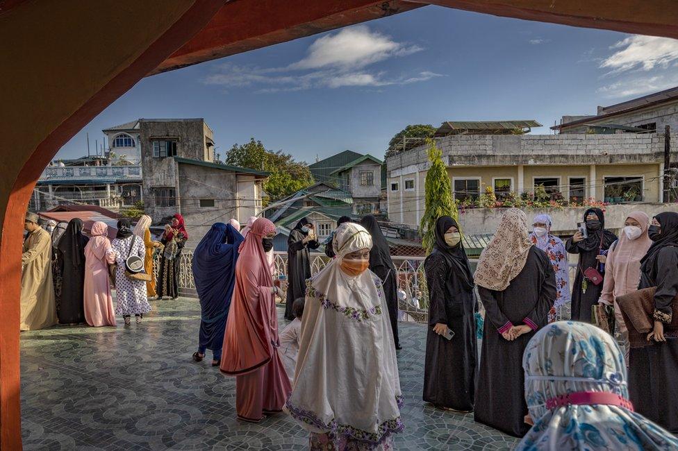 Muslims wear face masks as they celebrate Eid al-Fitr at the Garden Mosque in Taguig, Metro Manila, Philippines