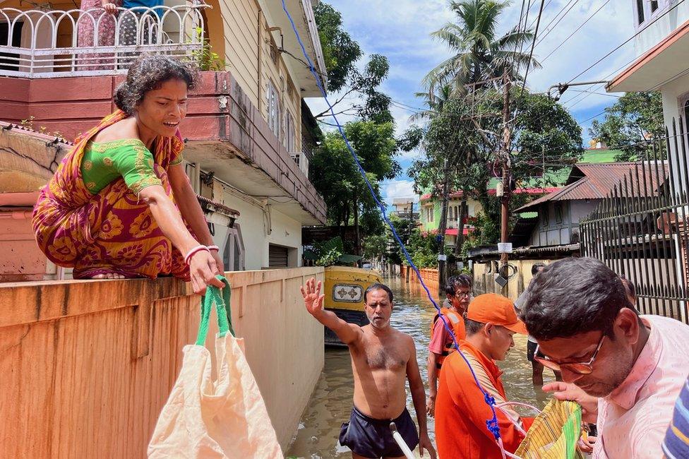 A woman seen taking aid from the NDRF