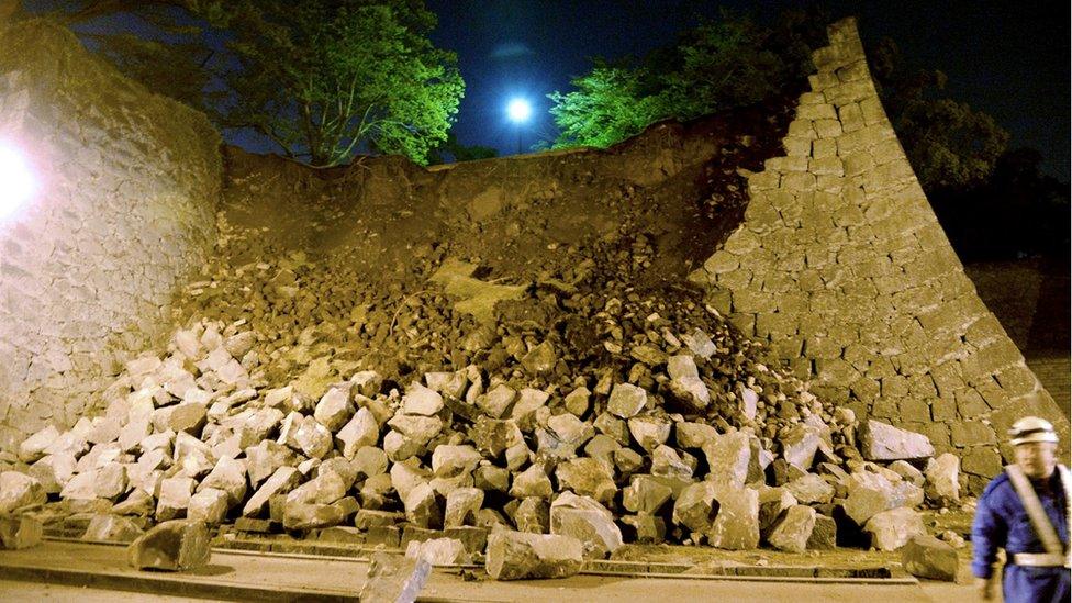 Stone walls of Kumamoto castle fall after an earthquake in Kumamoto, southern Japan, Thursday, April 14, 2016