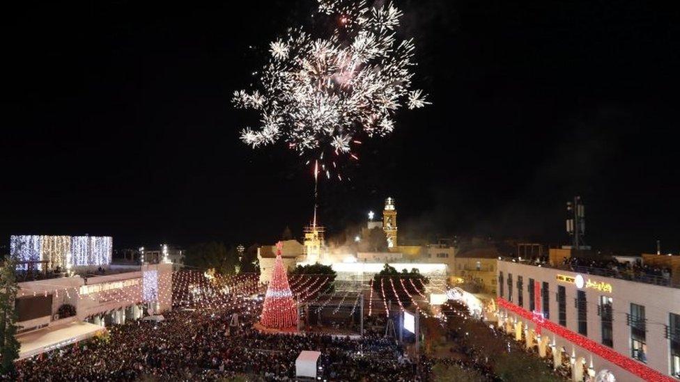 People celebrate during the lighting ceremony of a Christmas tree outside the Church of Nativity in the West Bank city of Bethlehem. Photo: 2 December 2017