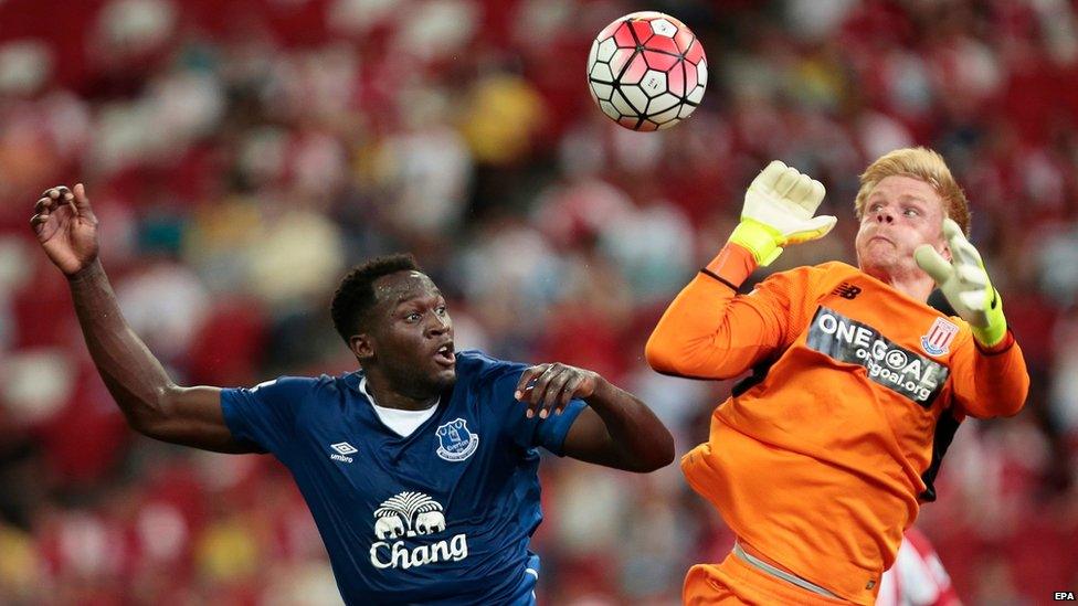 Everton's Romelu Lukaku (L) in action against Stoke City's goalkeeper Jakob Haugaard (R) during the Barclays Asia Trophy soccer match between Everton FC and Stoke City at the National Stadium in Singapore