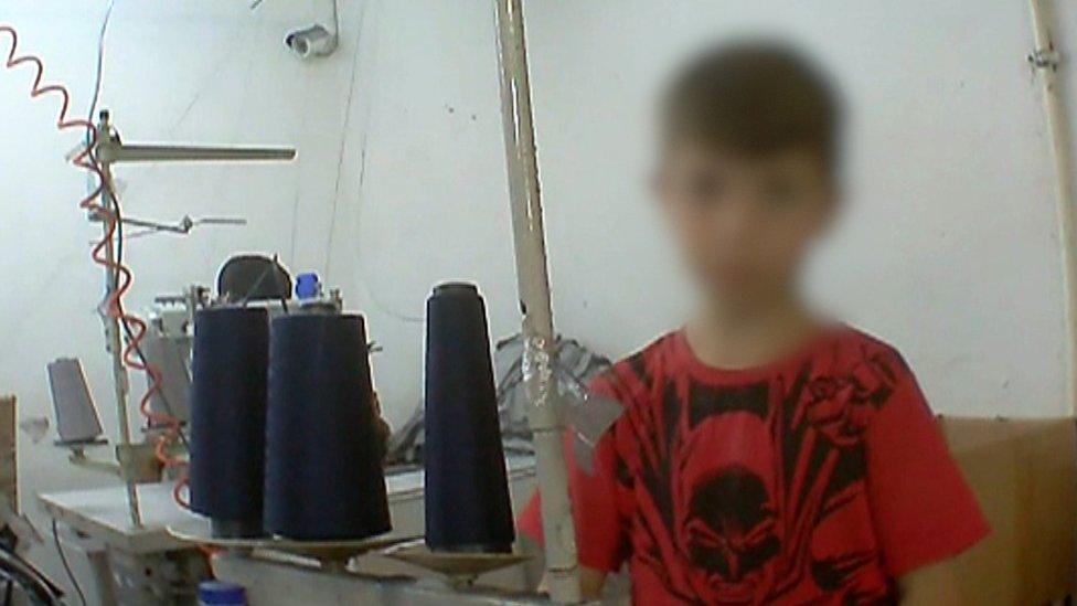 Young boy working in factory