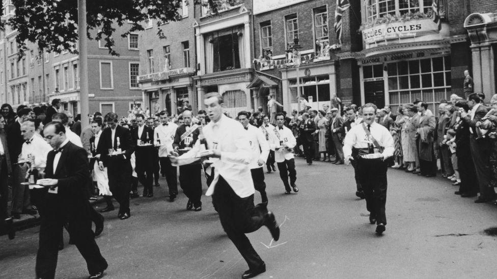 annual waiters' race from Soho Square to Greek Street, in London's Soho, 1955.