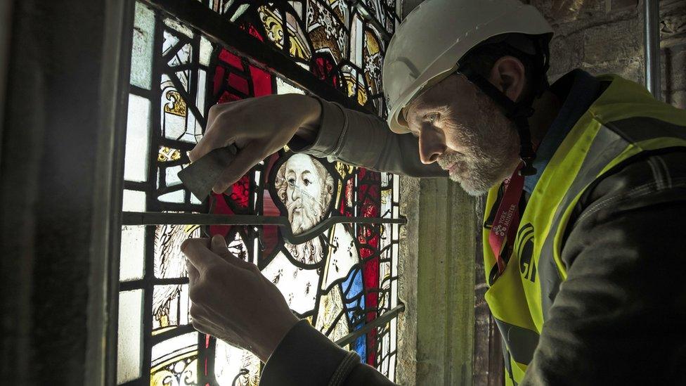 Conservation Manager Nick Teed removes a stained glass window during the first phase of work to protect 600-year-old stained glass windows