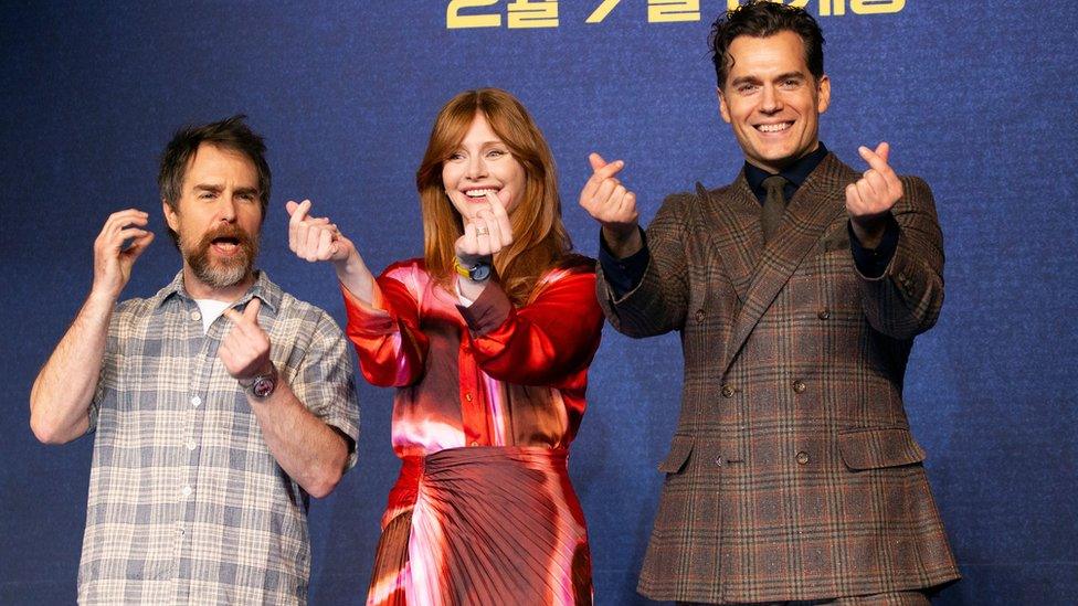 Sam Rockwell, Bryce Dallas Howard and Henry Cavill pose for photographs during a press conference for the premiere of Argylle