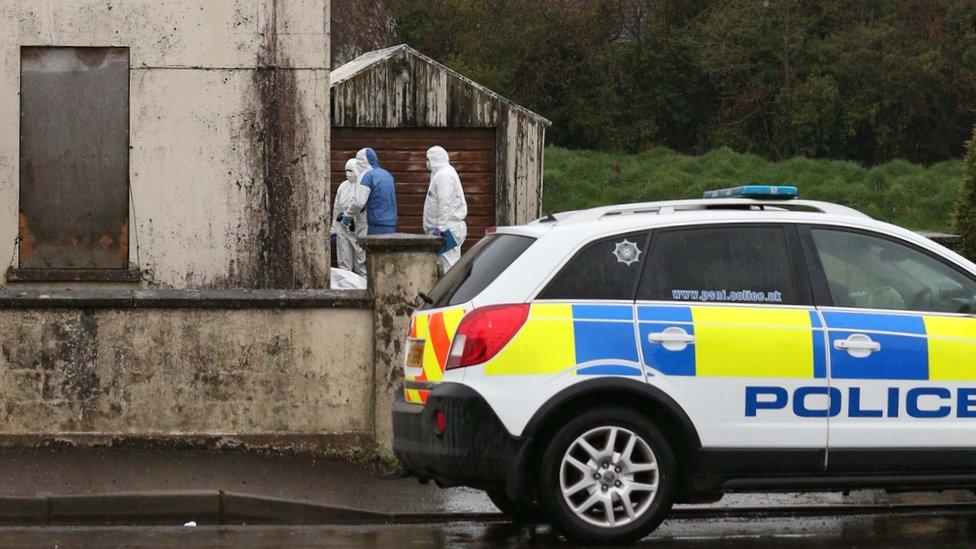 Forensic investigators at the building where Piotr Krowka's body was found