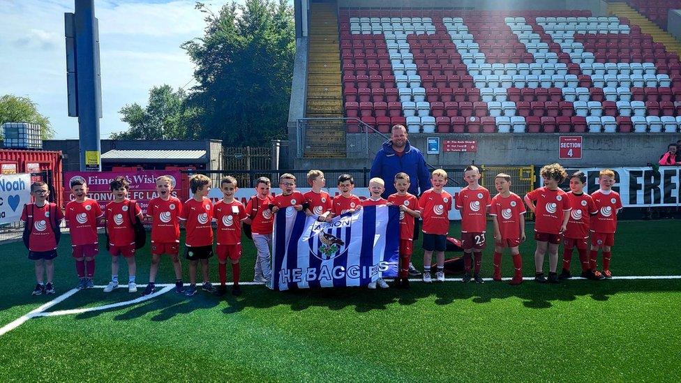 The group got their photo taken at Cliftonville Football Club on Friday