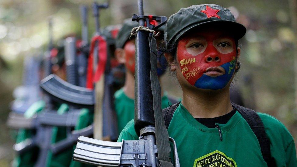 A photo taken on 23 November 2016, showing members of the New People's Army carrying guns.