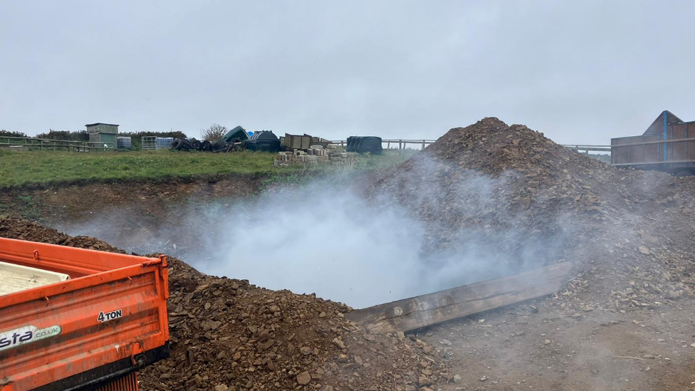 Rubbish being burnt in a pit