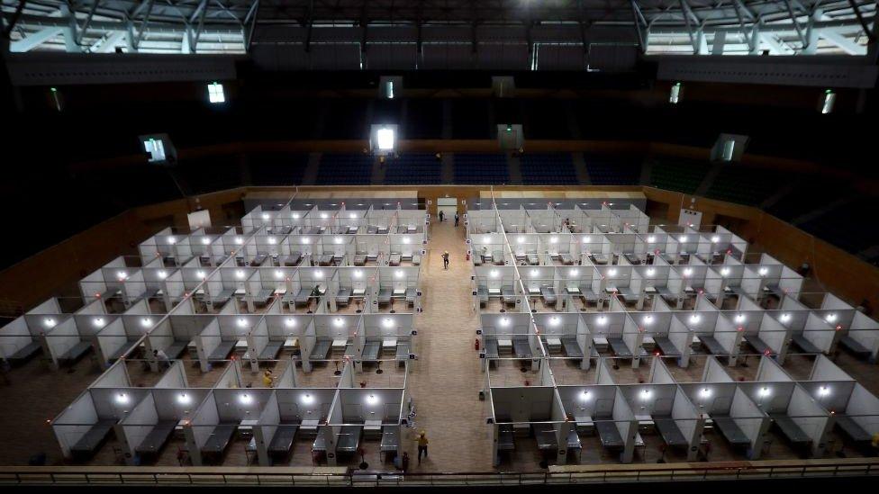 Workers prepare a makeshift field hospital inside the Tien Son sports complex amid the spread of the COVID-19 coronavirus in Da Nang on August 5, 2020.