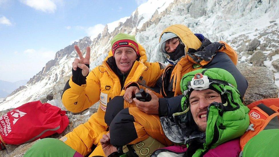 Russian climber Denis Urubko, French climber Elisabeth Revol, and Polish climber Adam Bielecki pose for a picture at the base of the Nanga Parbat on 28 January