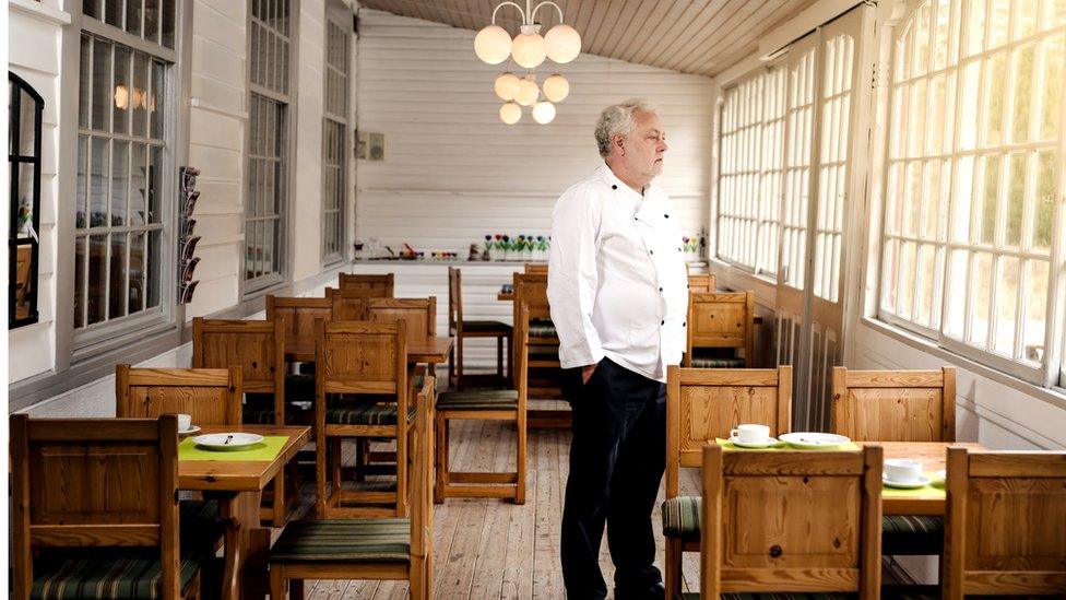 Restaurant owner in empty restaurant