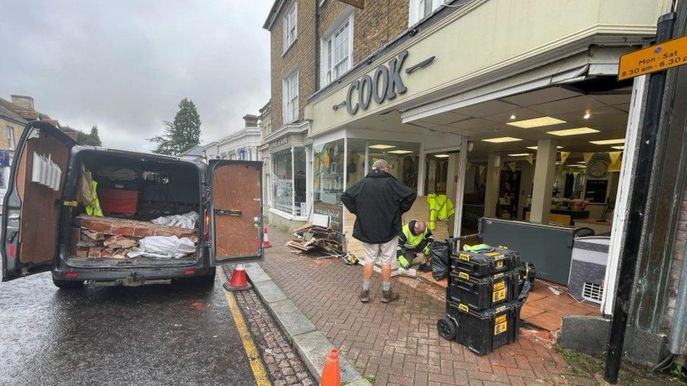 Debris outside the shop in Bishop's Stortford, Hertfordshire, where the truck crashed into