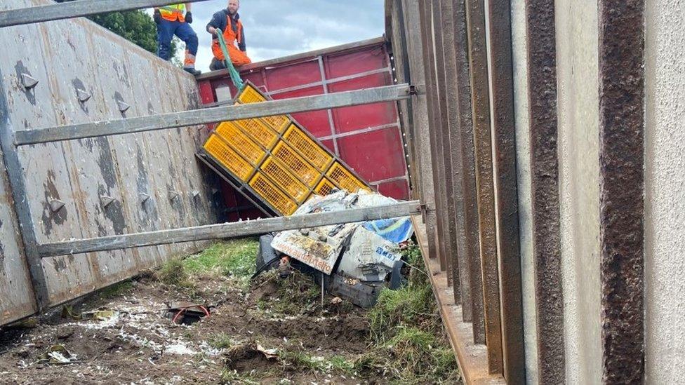 White van crushed under lorry