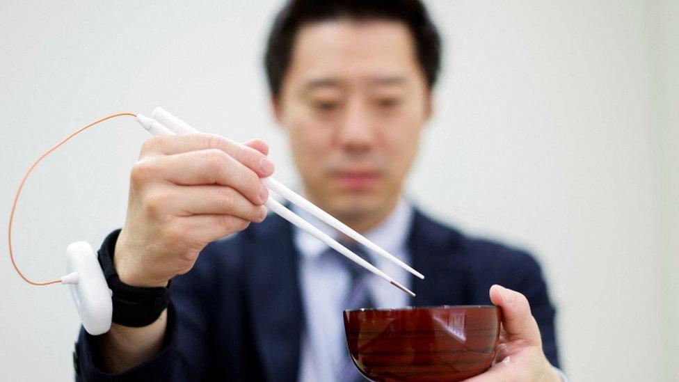 man-holding-chopsticks.
