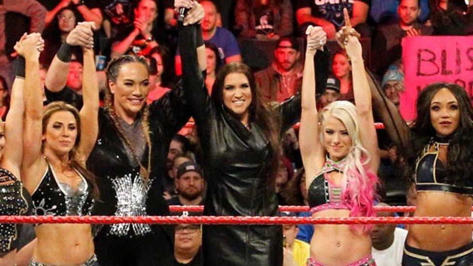 Stephanie McMahon, centre, in the WWE ring