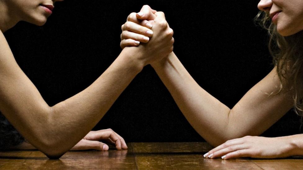 A stock picture showing two women arm wrestling