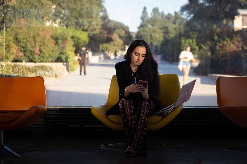 Yara Ismael works on a news column in between classes