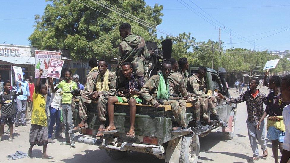 Protesters against the Somali president cheer Somali soldiers loyal to a break away military faction in the streets of Fagah cross in northern Mogadishu, Somalia, 25 April 2021