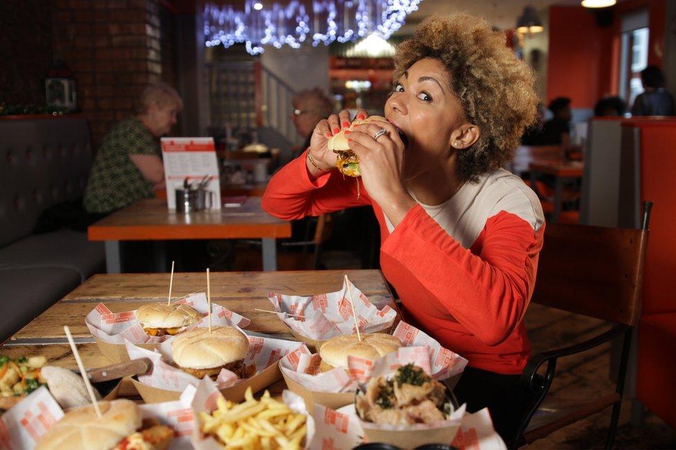 Zoe Williams eating a burger