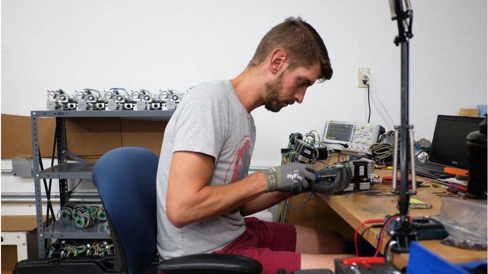 Employee works on a 3D-gun printing machine