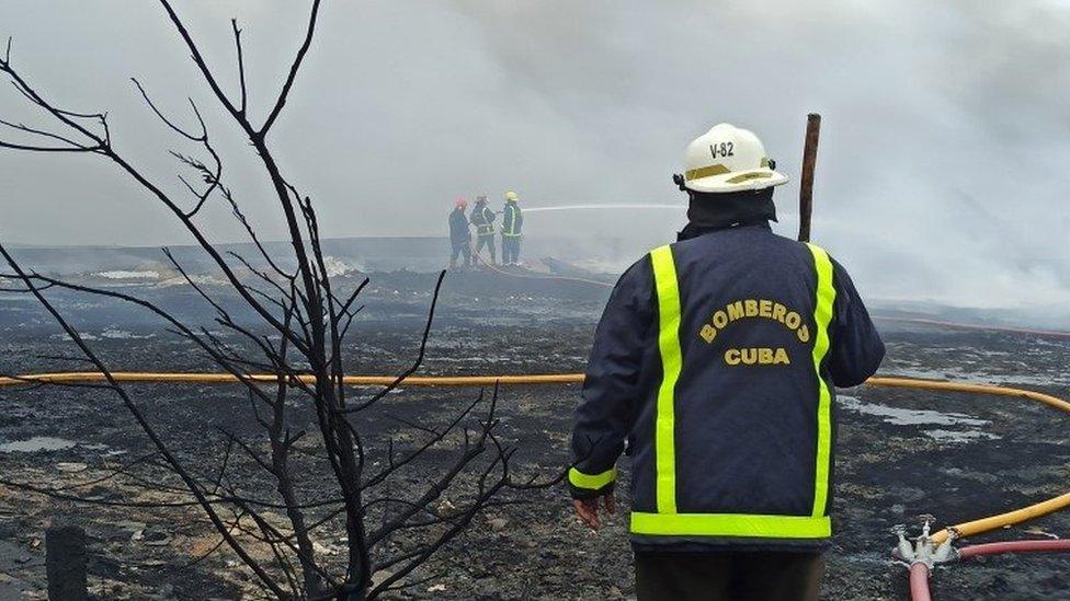 Firefighters work to extinguish a fire after the explosion at the container base in the industrial area of Matanzas Bay, Cuba, 09 August 2022.