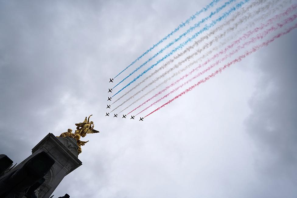 A view of flypast by aircraft from the Red Arrows over the Mall