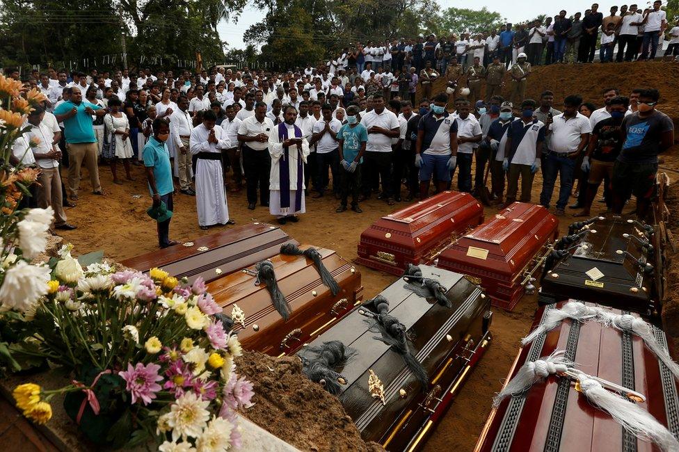 People participate in a mass funeral, for seven victims belonging to one family, in Negombo, Sri Lanka, 24 April