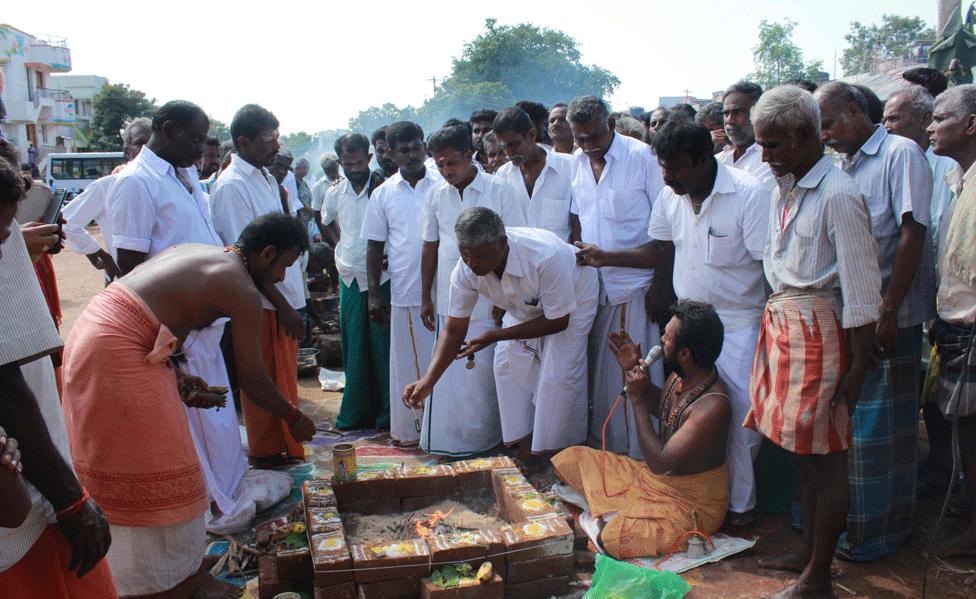 Prayer protest against bullfighting ban is held in empty bullfighting arena in village of Palamedu near Madurai, December 2015