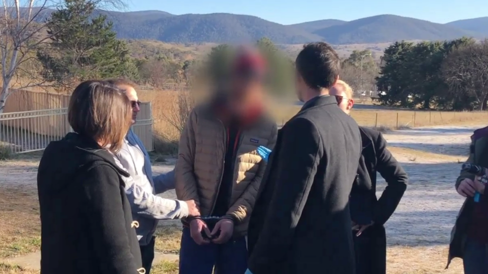 Detectives arrest Matthew James Williams (centre) in Jindabyne last year