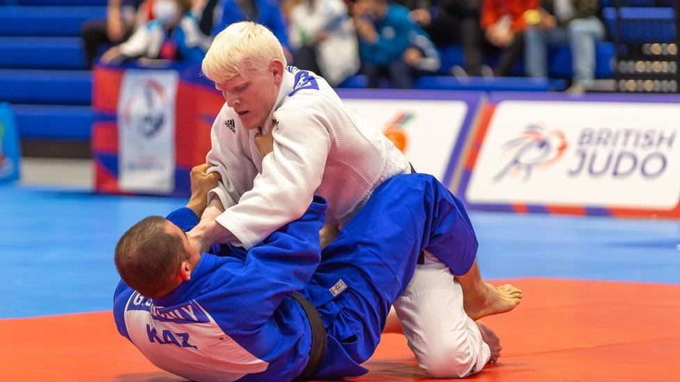 Evan Molloy in a judo fight wrestling another man